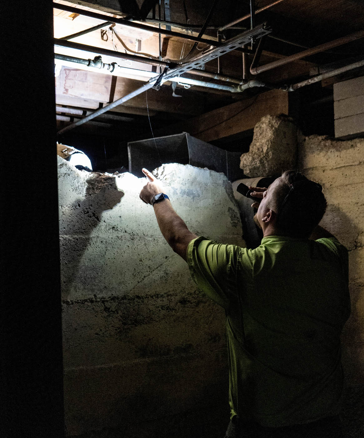 A GGA Pest Management technician performing an inspection for termites.