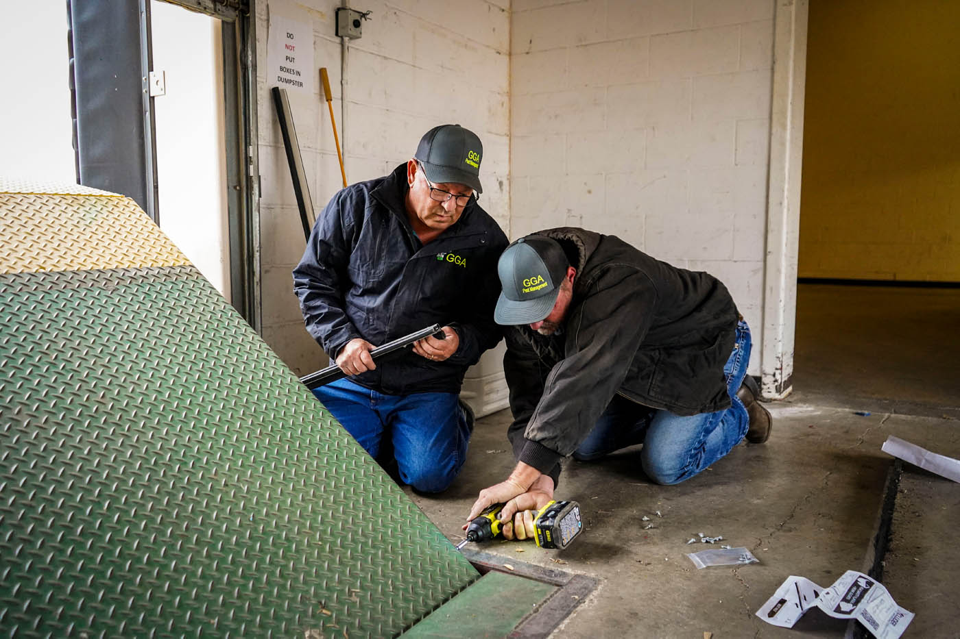 Two GGA technicians providing expert insect control in Hillsboro, TX.
