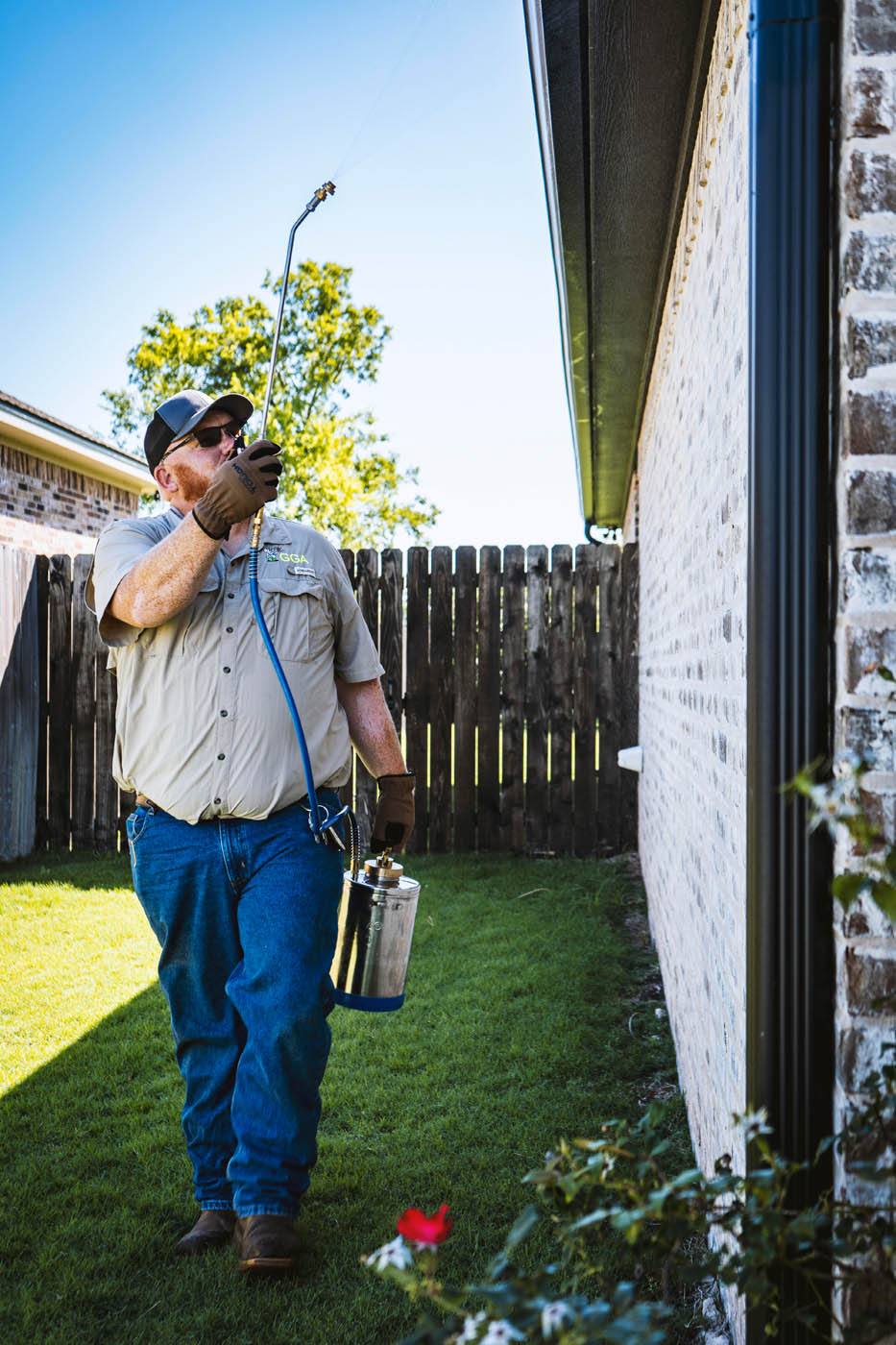 A GGA Pest Management insect exterminator in Temple, TX sparying a house.