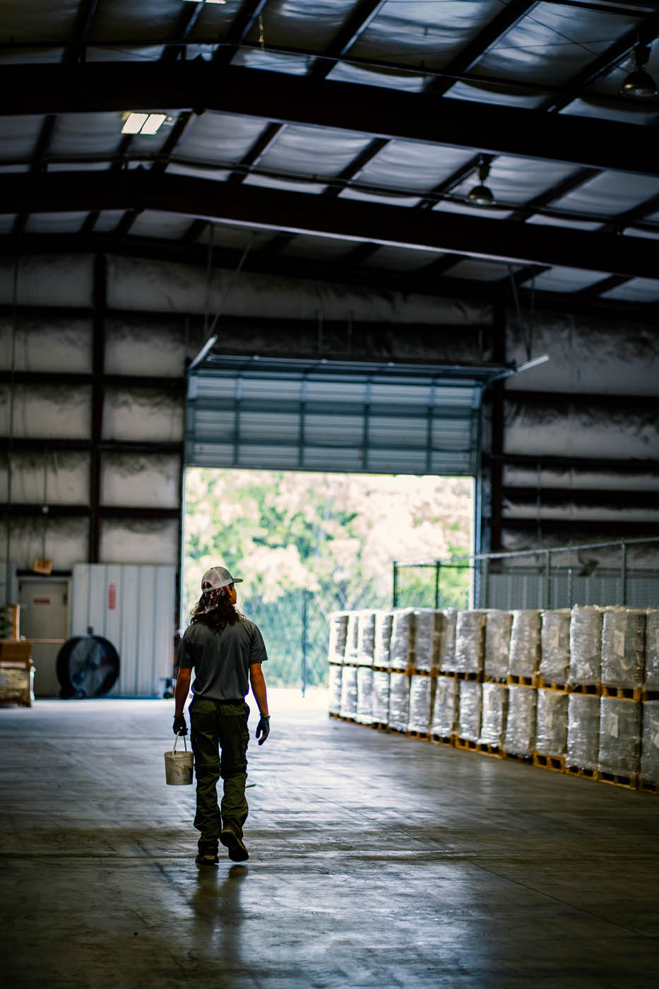 A GGA Pest Management technician walking through a warehouse.