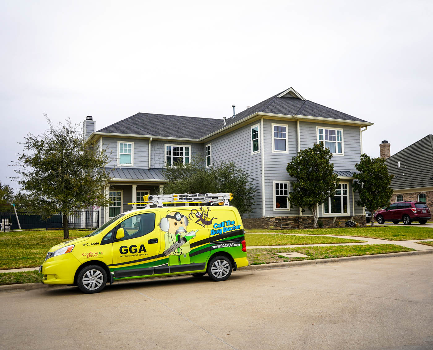 A GGA Pest Management vehicle in front of a residential home - learn how we can help with our roach exterminator services in Temple, TX.